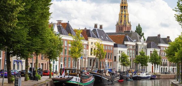 Historic ships, canal houses and warehouses on the old harbor at © Jan van der Wolf - stock.adobe.c